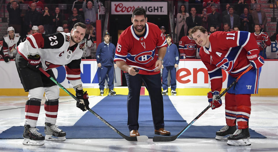 Laurent Duvernay-Tardif of the Kansas City Chiefs gets set to drop the ceremonial puck along with Montreal's Brendan Gallagher and Arizona's Oliver Ekman-Larsson. (Photo by Francois Lacasse/NHLI via Getty Images)