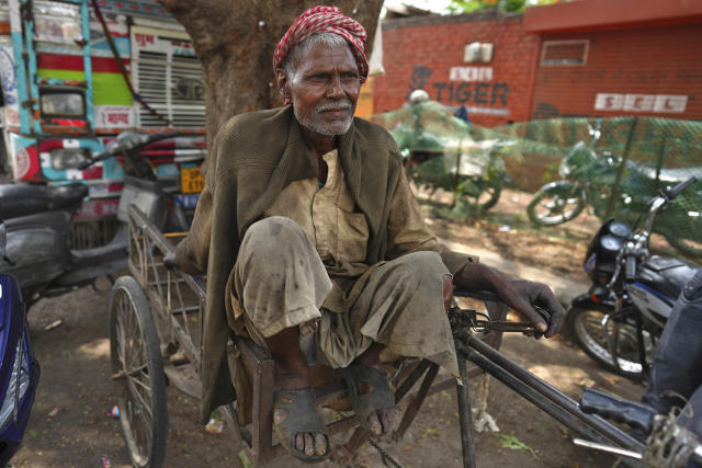 An elderly daily wage laborer takes a break at work on May Day in Prayagraj, India, Monday, May 1, 2023. (AP Photo/Rajesh Kumar Singh)