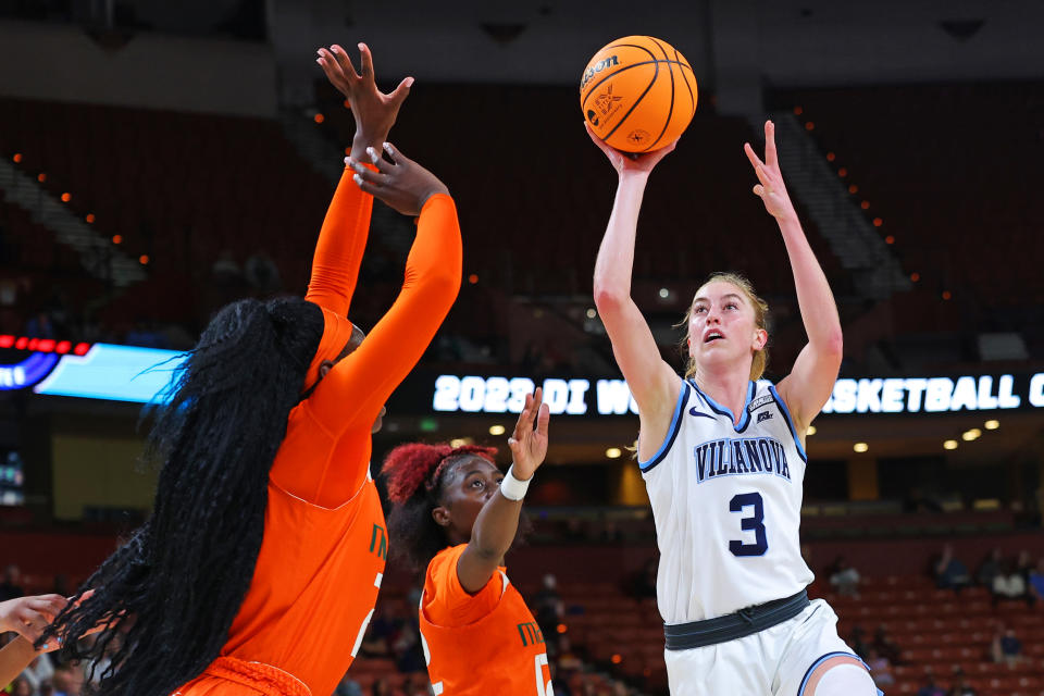 GREENVILLE, SOUTH CAROLINA – MARCH 24: Lucy Olsen #3 of the Villanova Wildcats shoots the ball against Destiny Harden #3 of the Miami Hurricanes and Lola Pendande #21 of the Miami Hurricanes during the second quarter in the Sweet 16 round of the NCAA Women’s Basketball Tournament at Bon Secours Wellness Arena on March 24, 2023 in Greenville, South Carolina. (Photo by Kevin C. Cox/Getty Images)