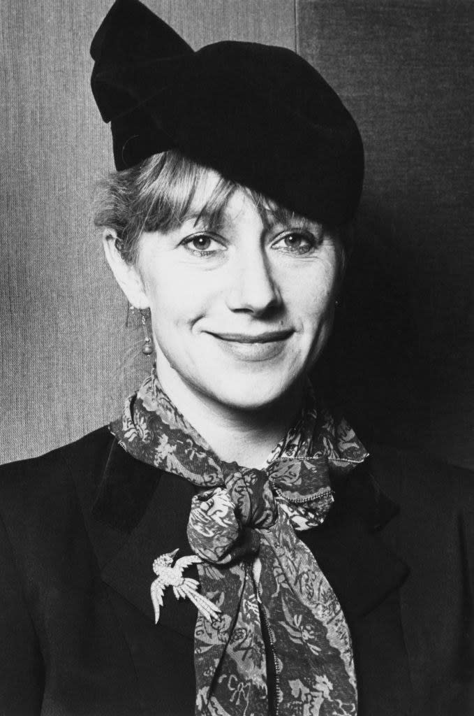 black and white headshot of Mirren smiling