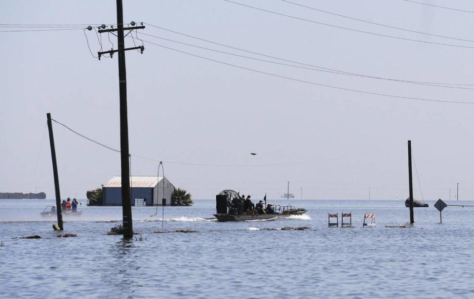 A boat is seen powering towards a flooded 6th Avenue Tuesday afternoon, April 25, 2023 just south of Corcoran, CA.