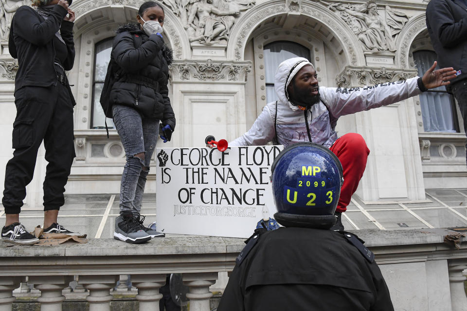 A man speaks to a police officer during scuffles with demonstrators at a Black Lives Matter march in London, Saturday, June 6, 2020, as people protest against the killing of George Floyd by police officers in Minneapolis, USA. Floyd, a black man, died after he was restrained by Minneapolis police while in custody on May 25 in Minnesota. (AP Photo/Alberto Pezzali)