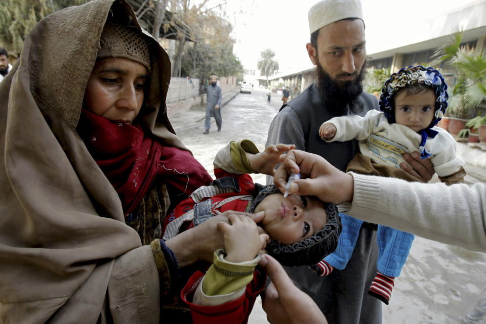 In this Feb. 2, 2014 photo, a health worker vaccinates a child against polio, in Peshawar, Pakistan. Pakistan’s beleaguered battle to eradicate polio is threatening a global, multi-billion dollar campaign to wipe out the disease worldwide. Because of Pakistan, the virus is spreading to countries that were previously polio free, say U.N. officials. “The largest poliovirus reservoir of the world,” is in Peshawar, the capital of Pakistan’s northwest Khyber Pukhtunkhwa province, which borders Afghanistan, according to the World Health Organization. (AP Photo/Mohammad Sajjad)