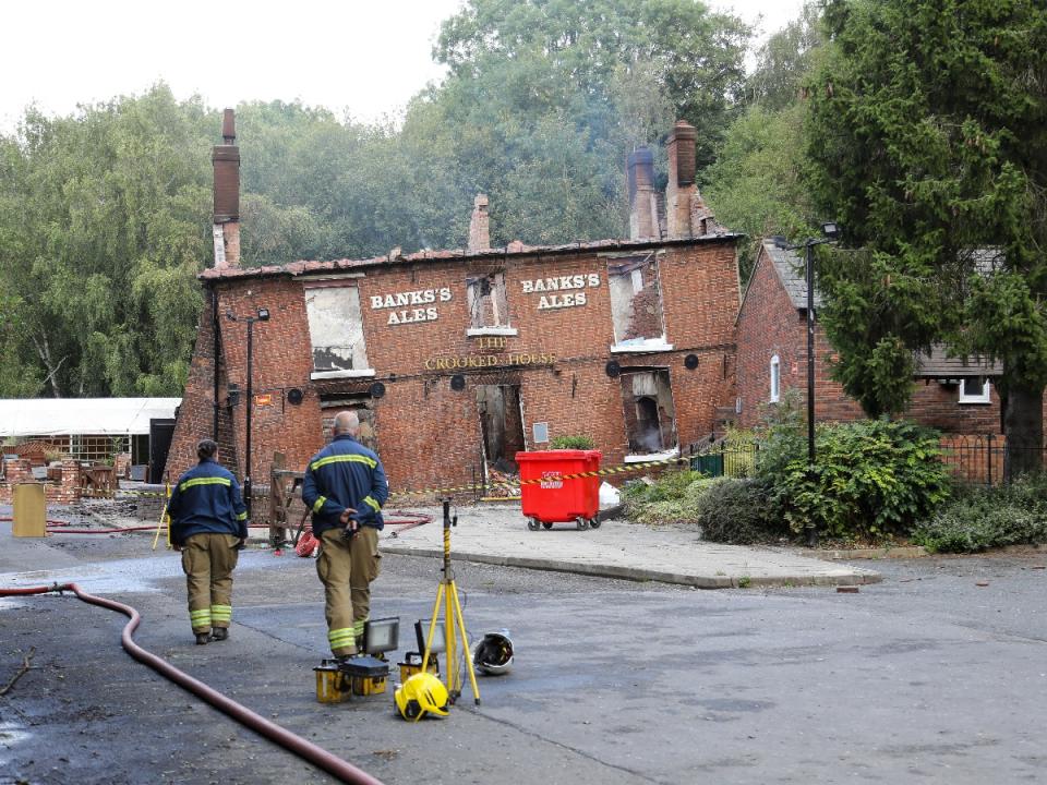 Firefighters at the scene of the suspected arson. (SWNS)