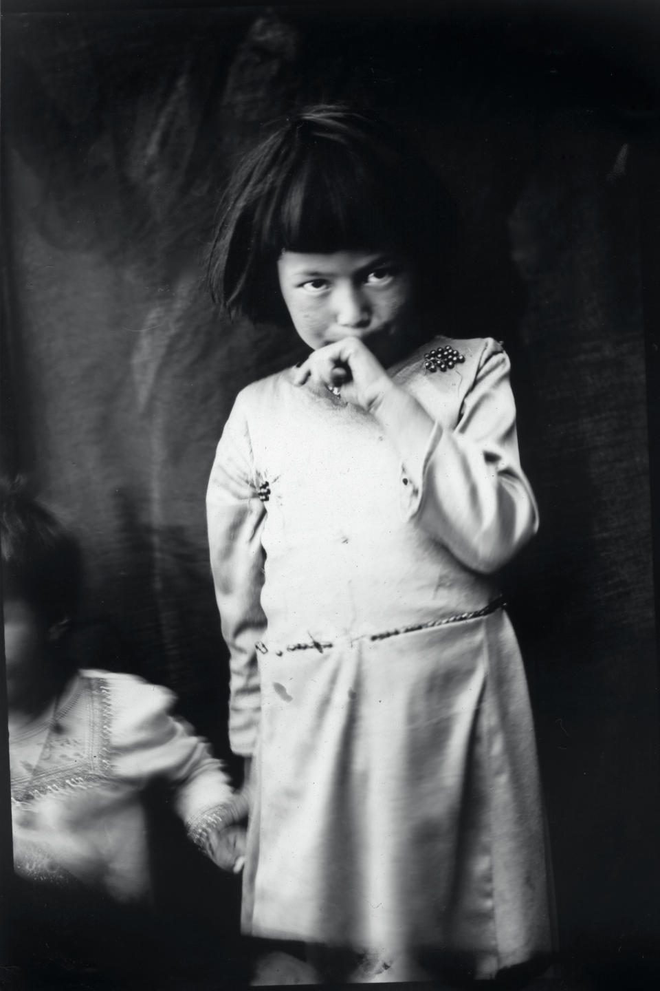 Khatira, 7, poses for a portrait outside her home near the remnants of the giant Buddha statue destroyed by the Taliban in 2001, in Bamiyan, Afghanistan, Sunday, June 18, 2023. (AP Photo/Rodrigo Abd)