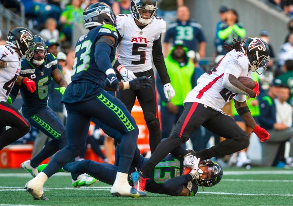 Seattle Seahawks strong safety Josh Jones (13) tackles Atlanta Falcons running back Cordarrelle Patterson (84) by grabbing his foot in the fourth quarter of an NFL game at Lumen Field in Seattle, Wash. on Sept. 25, 2022. The Seahawks lost to the Falcons 23-27.