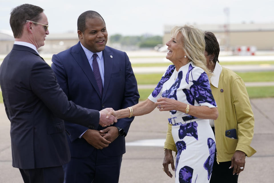 First lady Jill Biden is greeted by Dallas Mayor Eric Johnson, second from left, Rep. Eddie Bernice Johnson, D-Texas, obscured, and Dallas County Judge Clay Jenkins as she arrives at Love Field Airport in Dallas, Tuesday, June 29, 2021. (AP Photo/Carolyn Kaster, Pool)