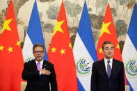 Chinese Foreign Minister Wang Yi and El Salvador's Foreign Minister Carlos Castaneda attend a signing ceremony to establish diplomatic ties between the two countries, at the Diaoyutai State Guesthouse in Beijing, China August 21, 2018. REUTERS/Jason Lee