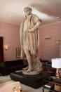 NEW YORK, NY - SEPTEMBER 19: The iconic 13-foot statue of Christopher Columbus is viewed from the 810-square-foot "living room" art installation by Japanese artist Tatzu Nishi on September 19, 2012 in New York City. Viewed as a piece of conceptual art, "Living Room", which sits 70-feet above ground level and is only accessible via a scaffold-encased staircase, has been temporarily built around the Columbus Monument in Columbus Circle. Beginning Thursday, up to 25 people at a time can enter the living room to view up close the 1892 marble figure of the Italian explorer. (Photo by Spencer Platt/Getty Images)