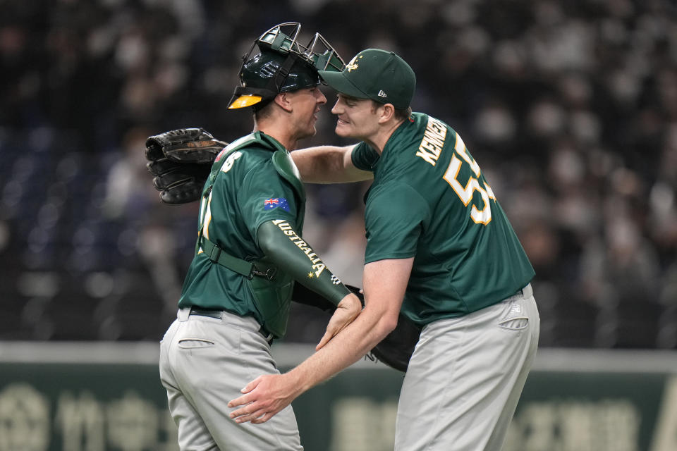 Australia's pitcher Jon Kennedy, right, and catcher Robert Perkins hug after winning over the Czech Republic during their Pool B game at the World Baseball Classic at Tokyo Dome in Tokyo, Japan, Monday, March 13, 2023.(AP Photo/Shuji Kajiyama)