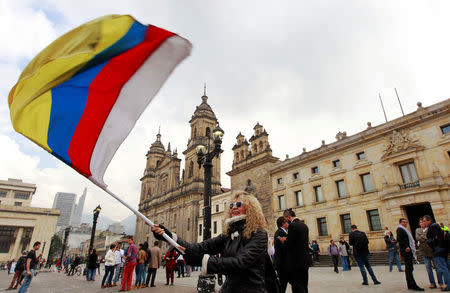 People demonstrate on the street as Colombia's President Juan Manuel Santos and Marxist FARC rebel leader Rodrigo Londono, known as Timochenko, sign a new peace accord in Bogota, Colombia November 24, 2016. REUTERS/Felipe Caicedo