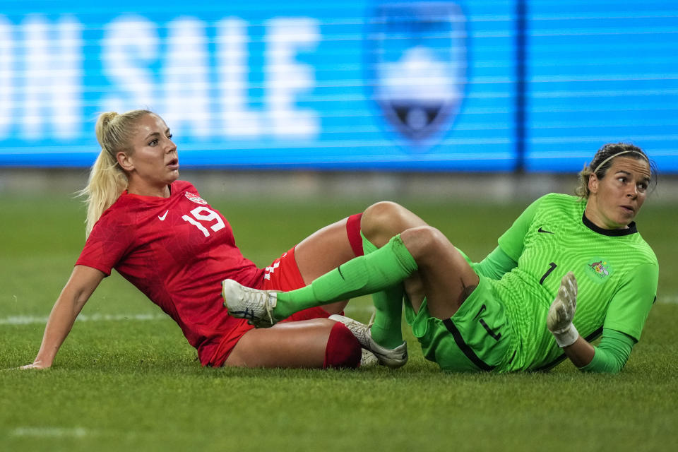 Canada's Adriana Leon, left, reacts as she scores her team's second goal as Australia's goalkeeper Lydia Williams watches during a friendly soccer international between Canada and Australia in Sydney, Australia, Tuesday, Sept. 6, 2022. (AP Photo/Rick Rycroft)