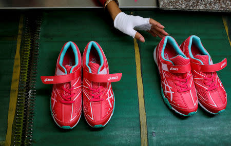 Shoes are being made at Complete Honour Footwear Industrial, a footwear factory owned by a Taiwan company, in Kampong Speu, Cambodia, July 4, 2018. REUTERS/Ann Wang