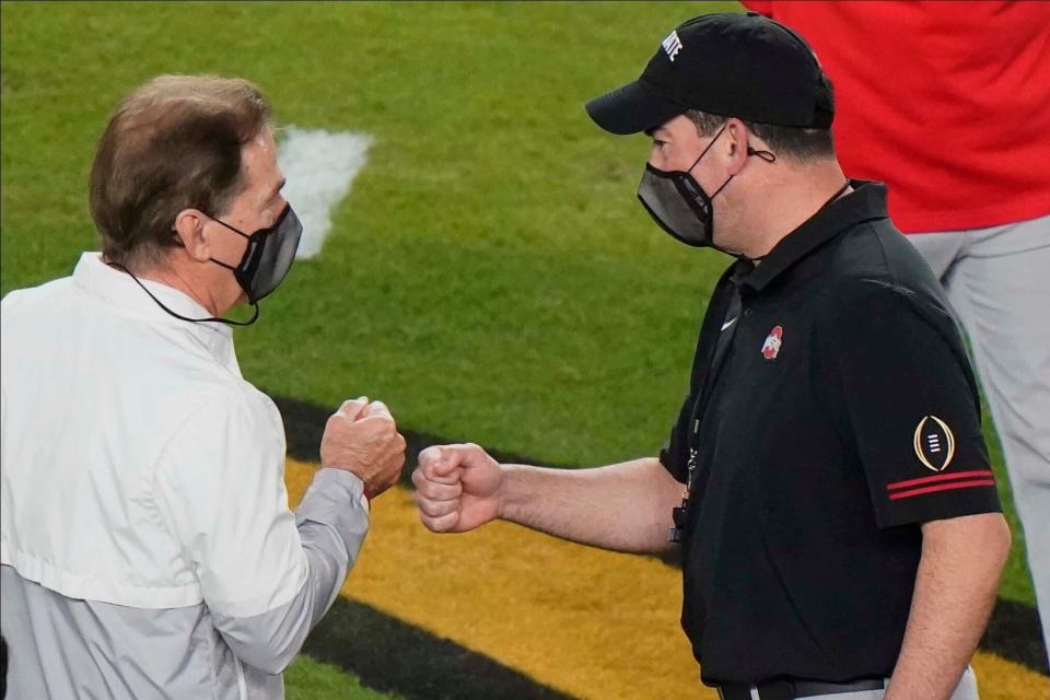 Alabama's Nick Saban, left, and Ohio State coach Ryan Day meet before the College Football Playoff championship game in January, 2021.