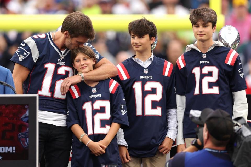 PHOTO: Tom Brady kisses his daughter, Vivian, while his sons, Benjamin and Jack, look on during a ceremony honoring Brady at halftime of New England's game against the Philadelphia Eagles at Gillette Stadium on Sept. 10, 2023 in Foxborough, Mass. (Maddie Meyer/Getty Images, FILE)