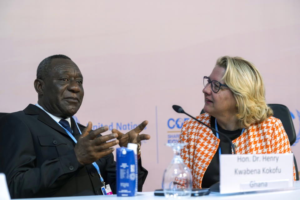 Henry Kwabena Kokofu, of Ghana, left, and Svenja Schulze, of Germany, talk at a session at the COP27 U.N. Climate Summit, Monday, Nov. 14, 2022, in Sharm el-Sheikh, Egypt. (AP Photo/Peter Dejong)