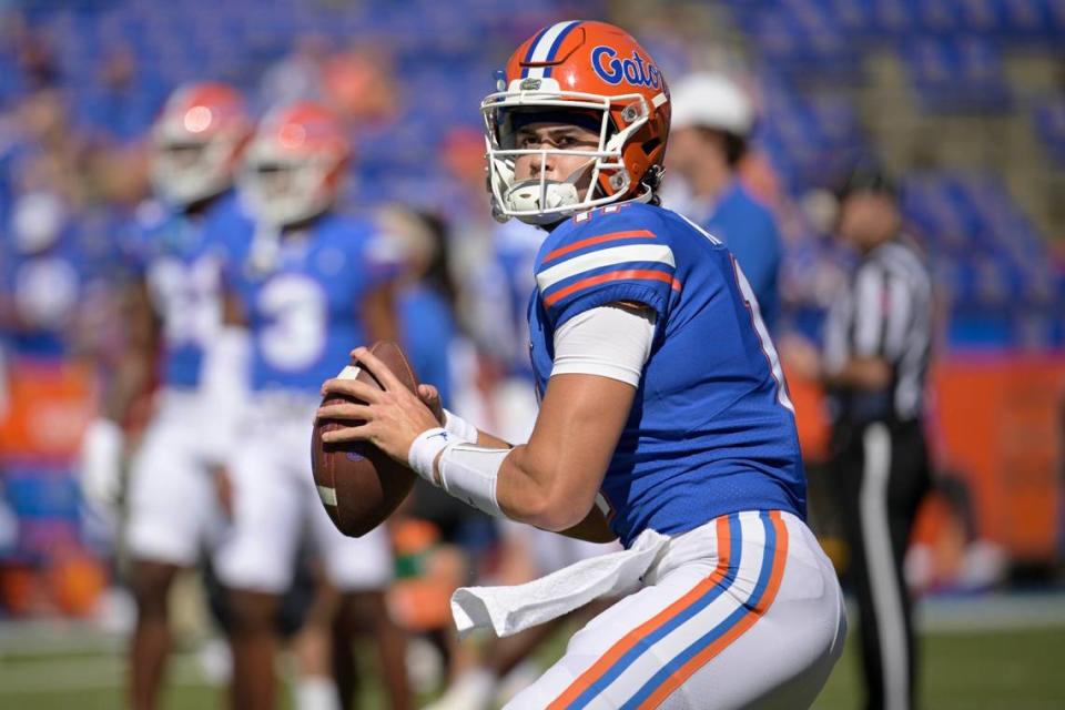 FILE -Florida quarterback Jalen Kitna (11) warms up before an NCAA college football game against Eastern Washington, Sunday, Oct. 2, 2022, in Gainesville, Fla. Florida backup quarterback Jalen Kitna, the son of retired NFL quarterback Jon Kitna, was arrested Wednesday, Nov. 30, 2022 and charged with two counts of distribution of child exploitation material and three counts of possession of child pornography. (AP Photo/Phelan M. Ebenhack, File)