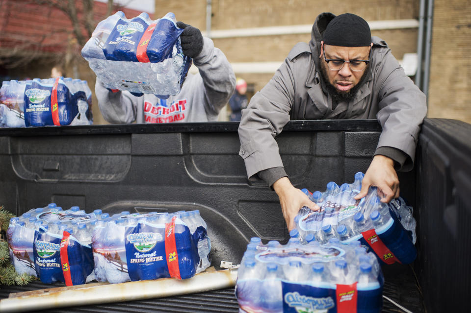 Volunteers load bottled water into a truck at the Sylvester Broome Center in Flint, Michigan, on Feb. 22, 2016. (Photo: Tom Williams/Getty Images)