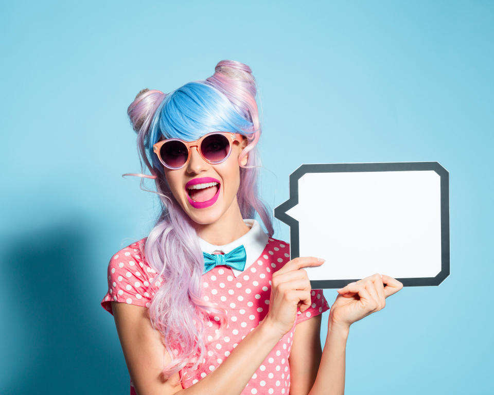 woman smiling holding a sign