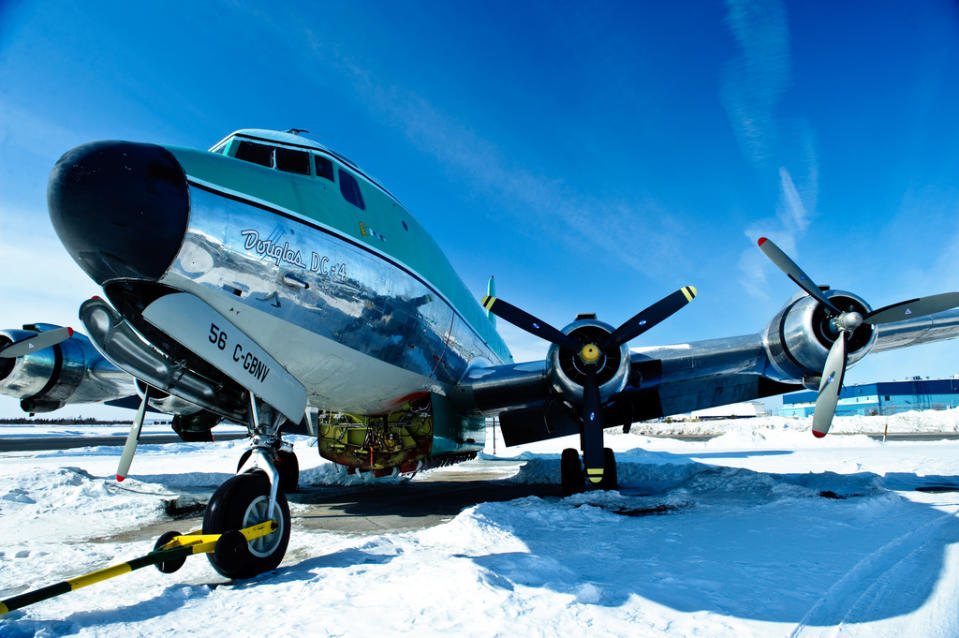 In this undated image released by The Weather Channel, a Buffalo Airways plane rests on a snow covered tarmac in a promotional photo from "Ice Pilots," airing Mondays at 9 p.m. EST on The Weather Channel. The Weather Channel is in the midst of a transformation with original programming about Arctic pilots, steel workers, wind turbine and power line repairers and Coast Guard rescuers in both icy and tropical climates. (AP Photo/The Weather Channel)