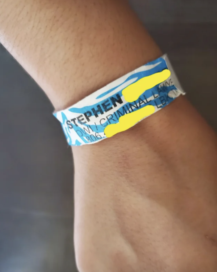 Wristband with a lawyer and bail bond number