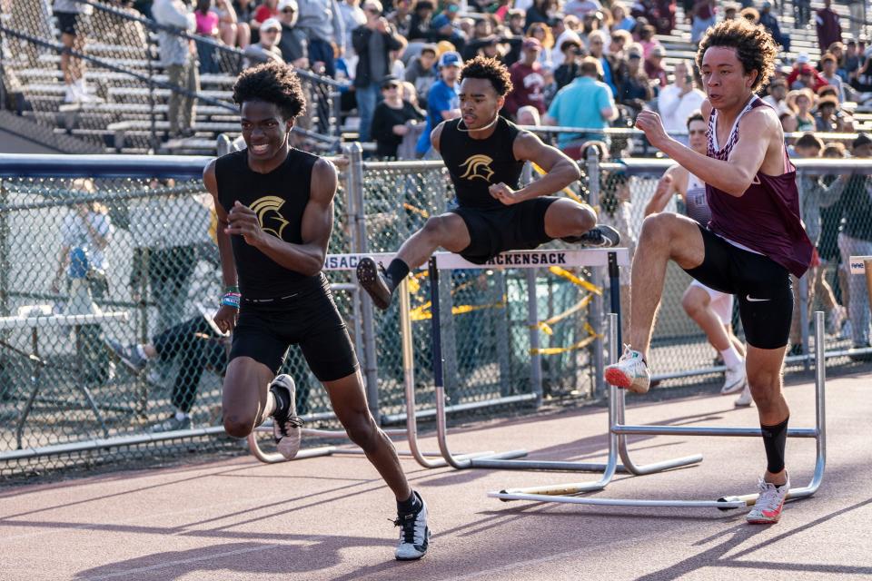 James Dely from Paramus Catholic, Cicai Jaramillo from Paramus Catholic and Victor Souza from Ridgewood compete in the 100 meter hurdles during the Lou Lanzalotto Bergen Meet of Champions at Hackensack High School on Friday, May 19, 2023. 