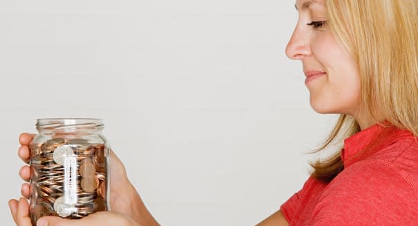 Woman holding jar of pennies