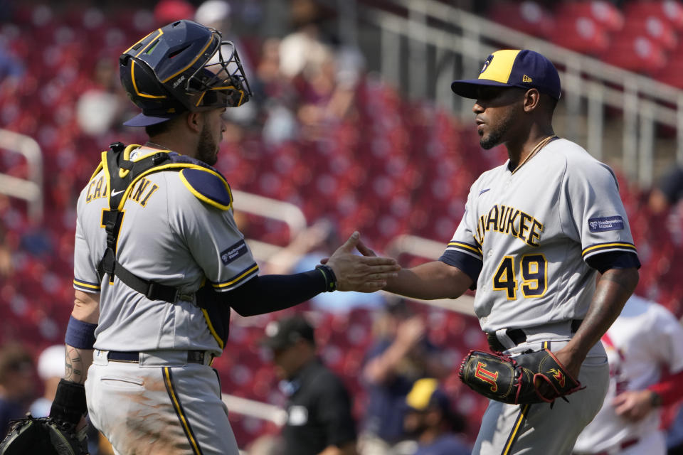 Milwaukee Brewers pitcher Julio Teheran (49) and catcher Victor Caratini (7) celebrate a 6-0 victory over the St. Louis Cardinals following a baseball game Thursday, Sept. 21, 2023, in St. Louis. (AP Photo/Jeff Roberson)