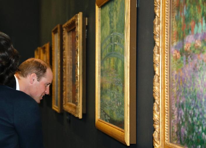 Britain's Prince William looks at a painting by French Impressionist Claude Monet at the Musee d’Orsay in Paris (AFP Photo/FRANCOIS GUILLOT)