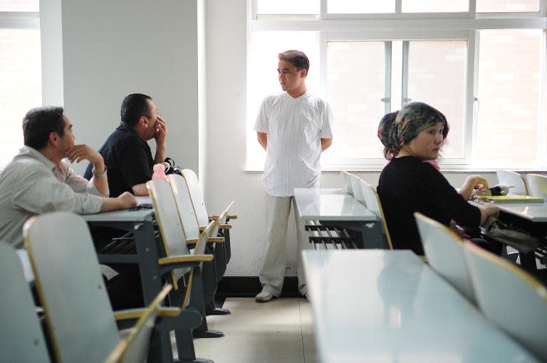 Economics professor Ilham Tohti, seen here chatting with his Beijing university students in June 2010, is well known in China for his moderate stance on Uighur issues