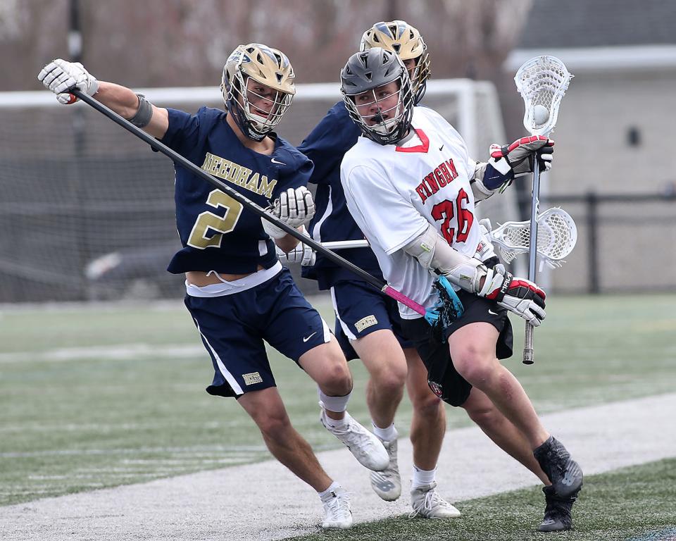 Hingham's Cian Nicholas looks to sprint past Needham's Kyle Piersiak during third quarter action of their game against Needham at Hingham High School on Saturday, April 9, 2022.