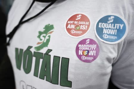 A Sinn Fein supporter shows Sinn Fein political stickers on his top at a polling station in West Belfast, Northern Ireland March 2, 2017. REUTERS/Clodagh Kilcoyne