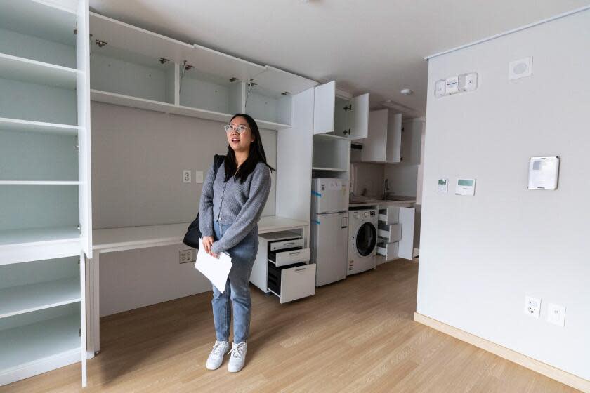 Seoul, South Korea-April 30, 2024-Kim Do-yeon, a new tenant for the 7-dollar apartment for youths, stands inside her room in Dongjak District in Seoul, South Korea. Government officials prepare for the gourds in front of the tenants for them to break them to ward off the evil spirit at the opening ceremony of the 7-dollar apartment for youths in Dongjak District in Seoul, South Korea. (Jean Chung / For The Times)