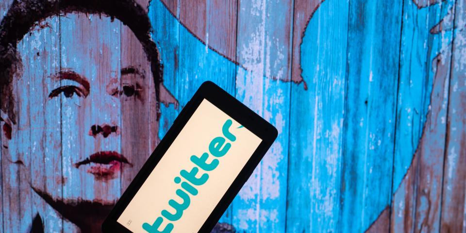 Elon Musk's Twitter account displayed on a mobile with Elon Musk in the background are seen in this illustration. In Brussels - Belgium on 19 November 2022. (Photo illustration by Jonathan Raa/NurPhoto via Getty Images)