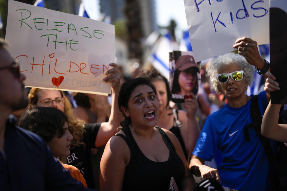 People shout slogans during a protest demanding the release of dozens of Israelis who have been abducted during last week's unprecedented Hamas attack, in Tel Aviv, Israel, Saturday, Oct. 14, 2023. (AP Photo/Francisco Seco)