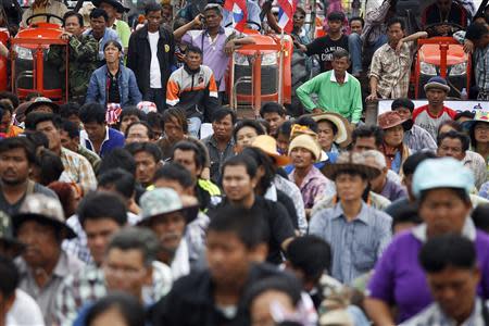 Rice farmers listen to a leader's speech on a highway where they spent the night among their tractors in Ayutthaya province February 21, 2014. REUTERS/Damir Sagolj