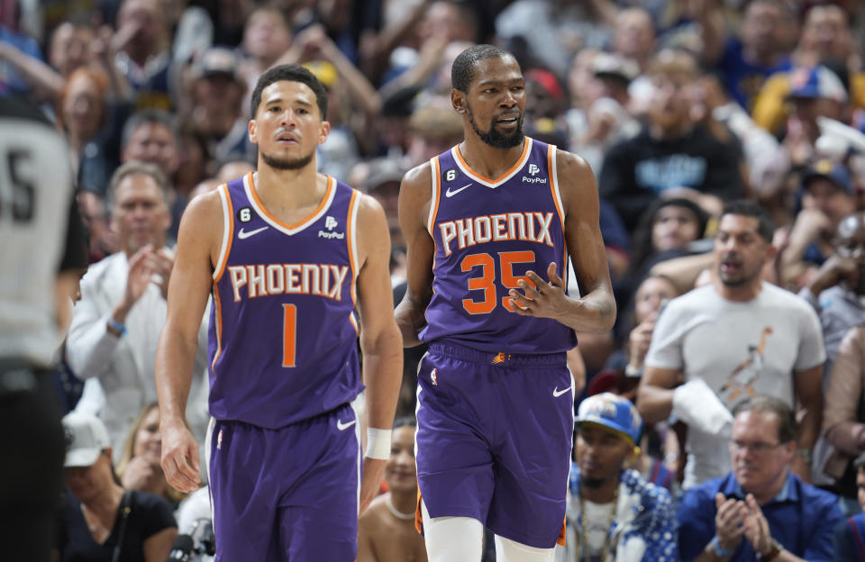Phoenix Suns guard Devin Booker (1) and Phoenix Suns forward Kevin Durant (35) in the second half of Game 5 of an NBA Western Conference basketball semifinal playoff series Tuesday, May 9, 2023, in Denver. (AP Photo/David Zalubowski)