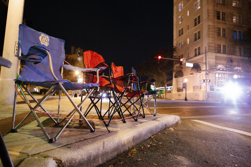 Chairs line the parade route in Downtown Lakeland on Tuesday, December 4, 2018. Though the annual Lakeland Christmas Parade isn't until Thursday evening, people loaded up their truck and vans with chairs and trekked downtown to stake their claim on the best viewing spots in town. [Laura L. Davis/The Ledger]