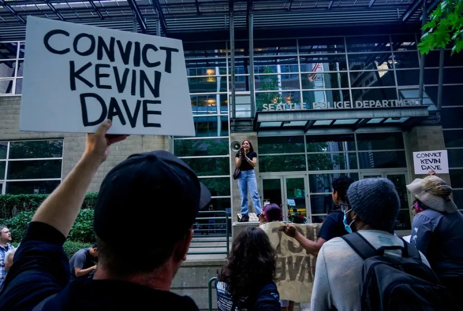 Kyla Carrillo, center, leads a chant on the steps of the Seattle Police Department’s West Precinct as people protest after body camera footage was released of a Seattle police officer joking about the death of Jaahnavi Kandula, a 23-year-old woman hit and killed in January by officer Kevin Dave in a police cruiser, Thursday, Sept. 14, 2023, in Seattle. (AP Photo/Lindsey Wasson)