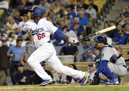 Oct 19, 2016; Los Angeles, CA, USA; Los Angeles Dodgers right fielder Yasiel Puig hits a single against the Chicago Cubs in the 9th inning during game four of the 2016 NLCS playoff baseball series at Dodger Stadium. Mandatory Credit: Richard Mackson-USA TODAY Sports