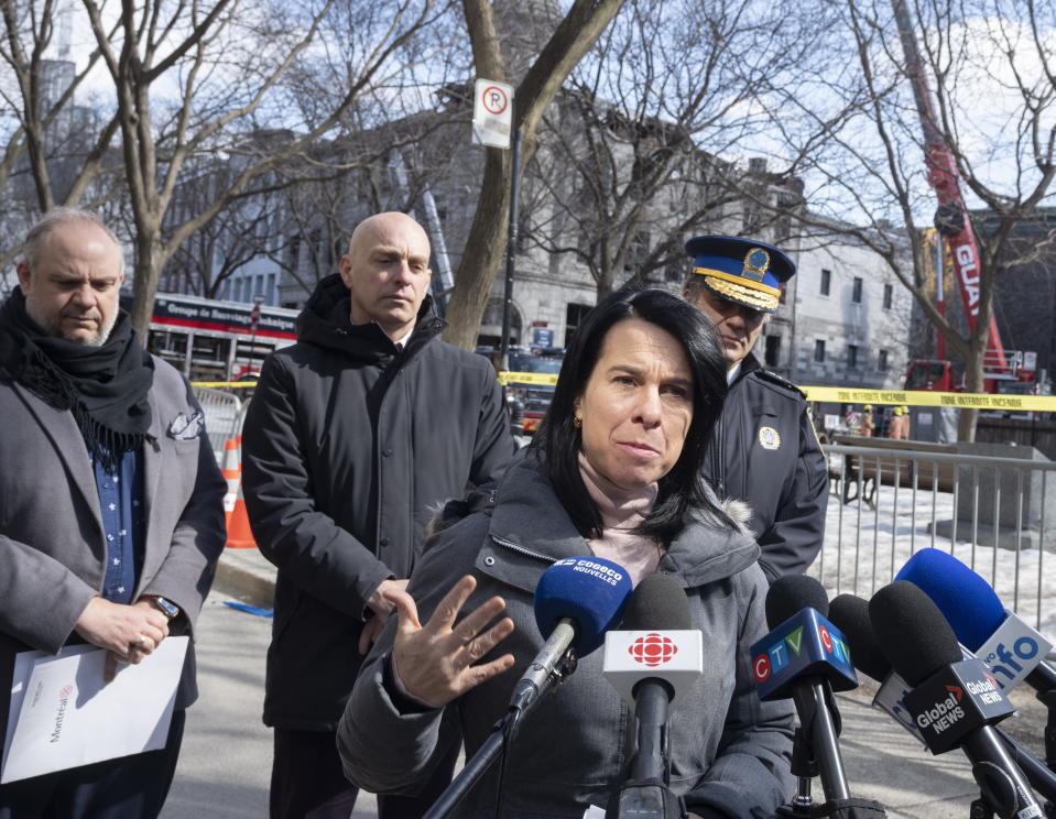 Montreal Mayor Valerie Plante speaks to the media Monday, March 20, 2023 at the scene of last week's fire in Montreal. Plante vowed to tighten regulation of Airbnb as a search continued for six people missing after a fire swept through a building that included Airbnb units in a historic city section where they are banned. (Ryan Remiorz/The Canadian Press via AP)
