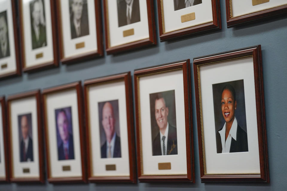 A portrait of Police Commissioner Keechant Sewell. bottom right, is displayed with the photos of previous NYPD commissioners, all male, at police headquarters in New York, Monday, Jan. 3, 2022. Sewell spent her entire policing career in suburban Long Island before recently becoming New York City's first police commissioner from outside the department in over two decades. (AP Photo/Seth Wenig)