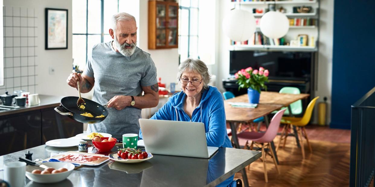 senior woman using laptop computer watching tv