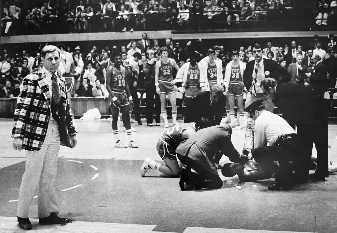 N.C. State coach Norm Sloan looks away as David Thompson is looked at after falling during N.C. State’s game against Pittsburgh in the Eastern Regional final at Reynolds in March 1974.