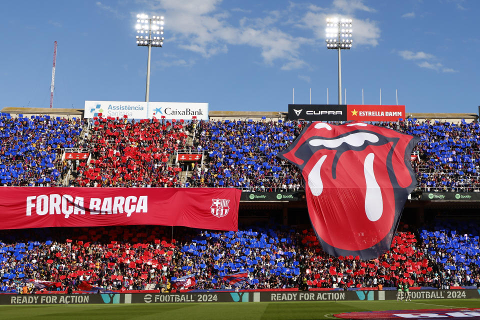 A big logo of the English rock band Rolling Stones unfolded on the stands during the La Liga soccer match between Barcelona and Real Madrid at the Olympic Stadium in Barcelona, Spain, Saturday, Oct. 28, 2023. (AP Photo/Joan Monfort)