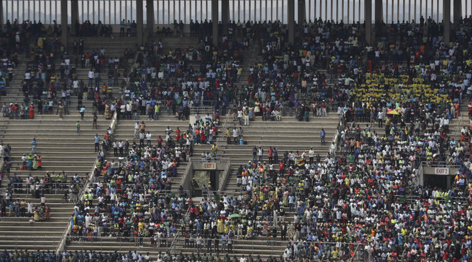 Mourners attend the funeral service for Former Zimbabwean President Robert Mugabe at the National Sports Stadium in Harare, Saturday, Sept. 14, 2019. African heads of state and envoys are gathering to attend a state funeral for Mugabe, whose burial has been delayed for at least a month until a special mausoleum can be built for his remains. (AP Photo/Themba Hadebe)