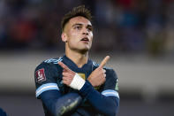 Argentina's Lautaro Martinez celebrates scoring his side's opening goal against Peru during a qualifying soccer match for the FIFA World Cup Qatar 2022 in Buenos Aires, Argentina, Thursday, Oct. 14, 2021. (AP Photo/Gustavo Garello)