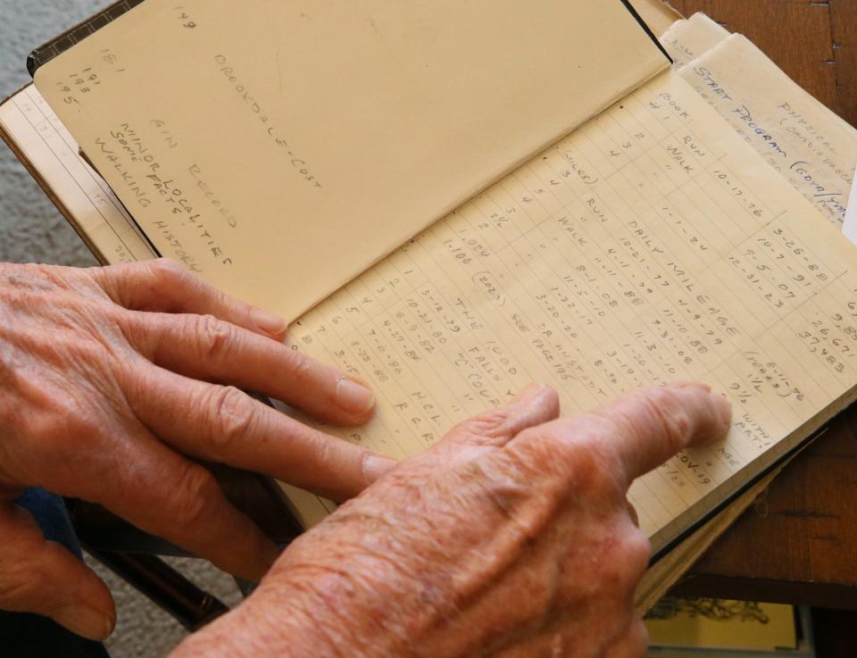 Jim Dahl, 95, looks over his fourth book of his walking progress in his independent living apartment at Brookdale Montrose.