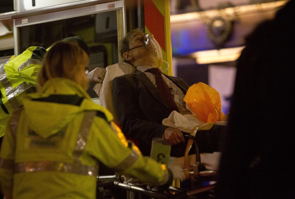 A man receives medical attention after part of the ceiling at the Apollo Theatre on Shaftesbury Avenue collapsed in central London