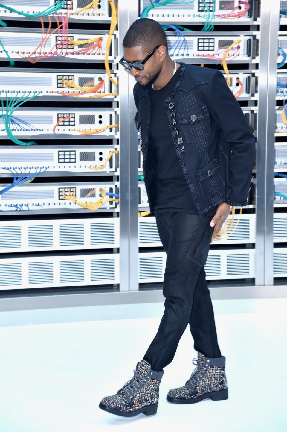 Usher sat in the frow and showed his support for the brand decked out in head-to-toe Chanel, from his Timberland-inspired boots to the pins on his jacket.